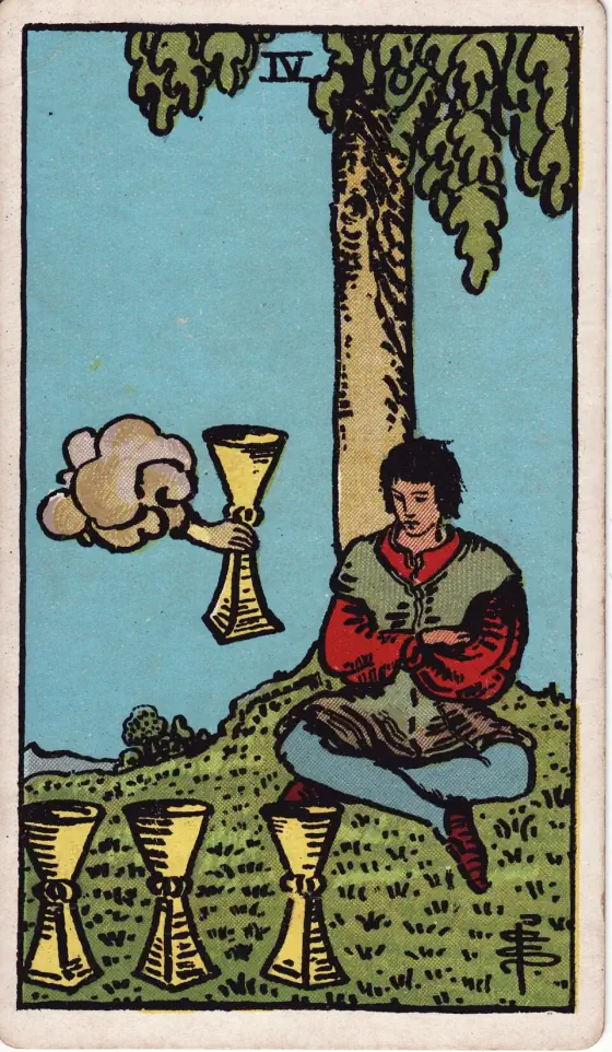 Four of Cups: A young man is seated under a tree and contemplates three cups set on the grass before him; an arm issuing from a cloud offers him another cup.
