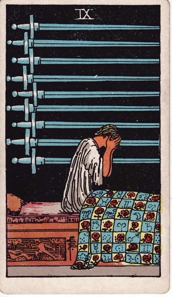 Nine of Swords: One seated on her couch in lamentation, with the swords over her.
